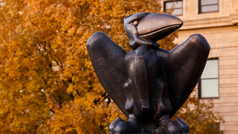 Bronze jay hawk statue in front of Strong Hall