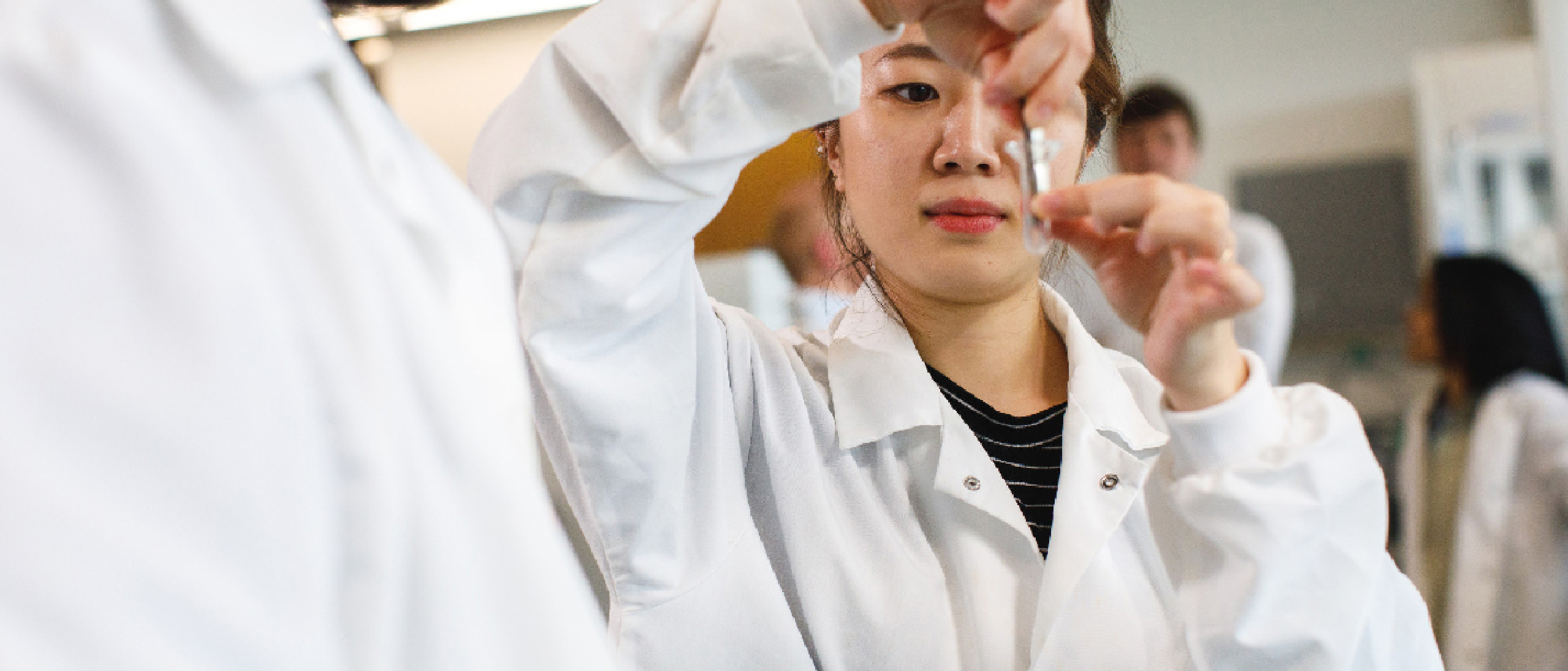Student places test material in glass vial