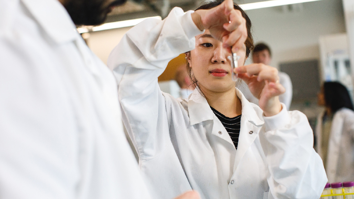 Students place sample in glass test tube